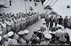 The surrender on the USS Missouri, September 2, 1945. General MacArthur, back to camera, stands at the table while General Yoshijiro Umezu, Chief of the Imperial Palace General Staff signs the surrender paper